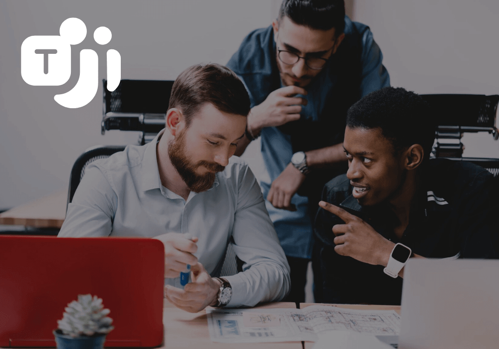 Photo of people collaborating at desk with Microsoft Teams logo